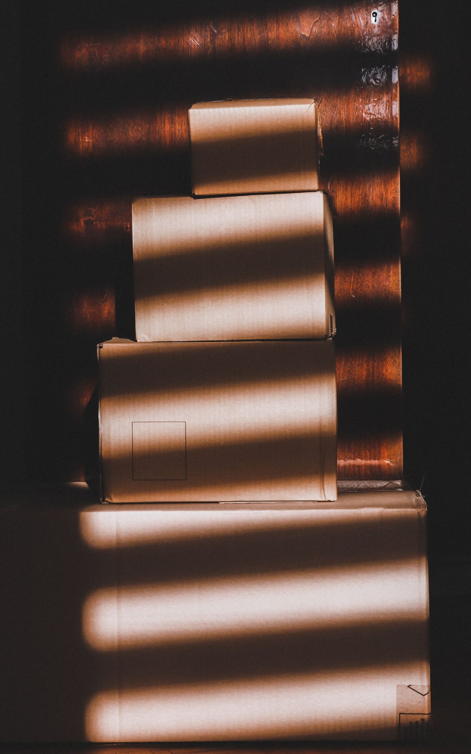 Stacked cardboard boxes in striped light