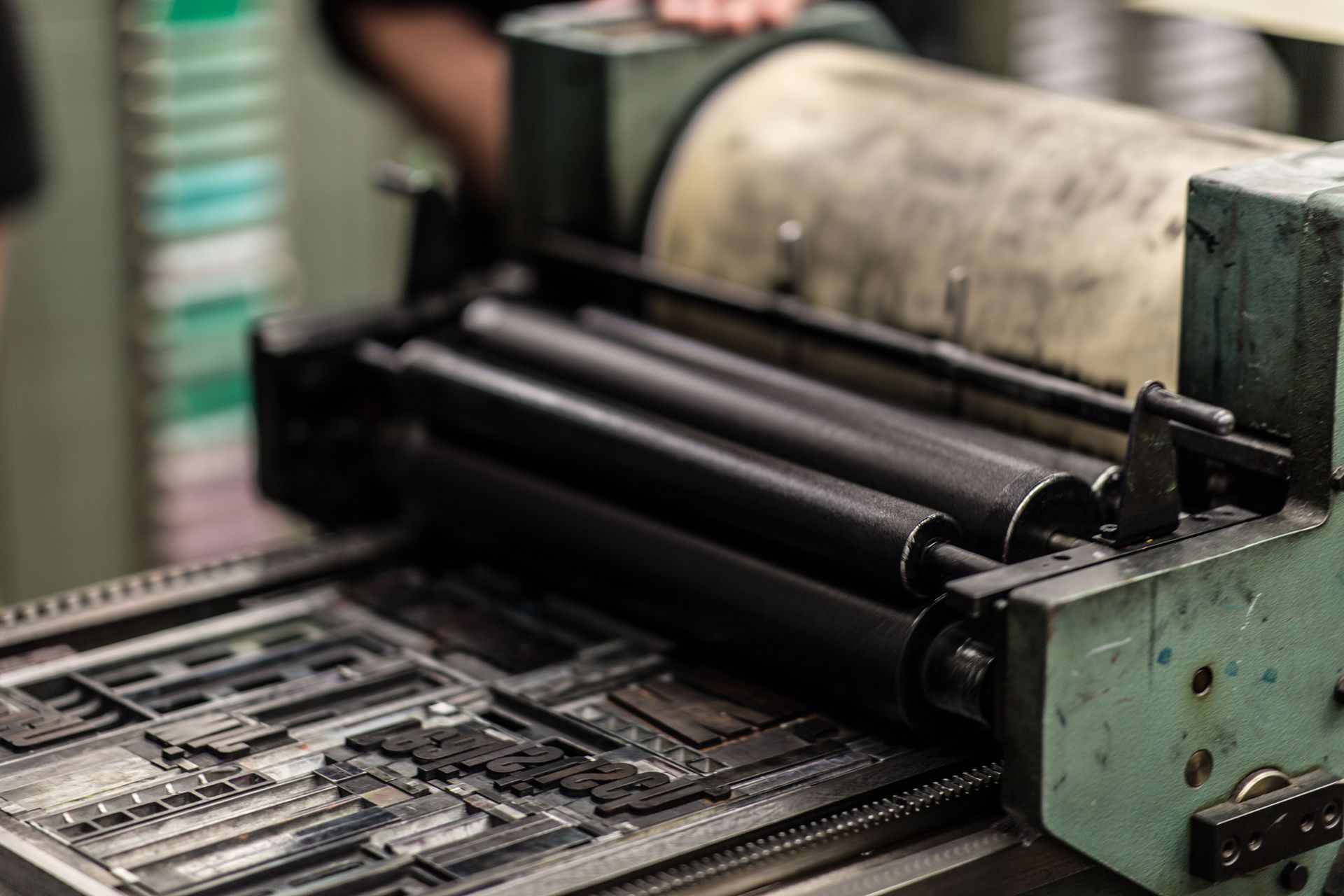 Printing press rollers and type in close-up